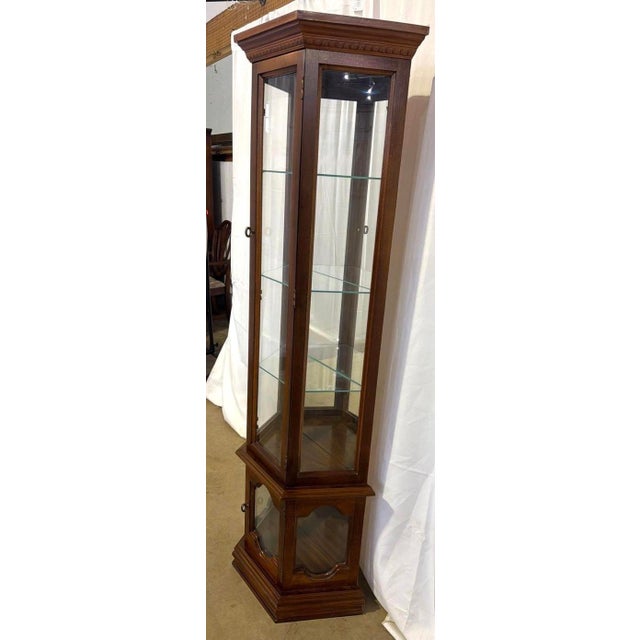Pulaski Walnut Lighted Curio Cabinet. It has 2 doors, three glass shelves. It measures 70”Hx 24”Wx 10 1/2”D. Local...