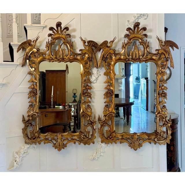 A striking and highly decorative pair of antique giltwood wall mirrors beautifully carved in the Rococo revival manner...