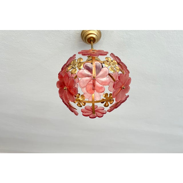 Add a warm, whimsical glow to your interior with this enchanting vintage Mid-Century style floral globe chandelier....