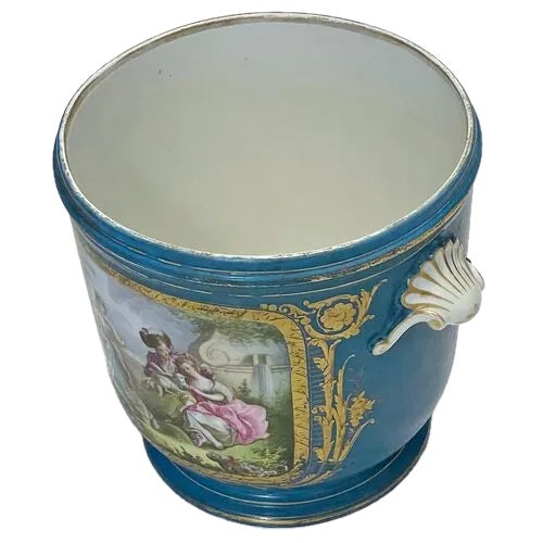 Large antique hand-painted porcelain Sevres cachepot with shell style handles. Hand-painted florals and renaissance period...