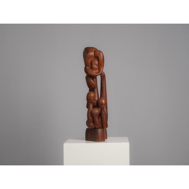 A beautifully carved abstract wood sculpture from the 1970s, executed in solid tropical hardwood. The composition is built...