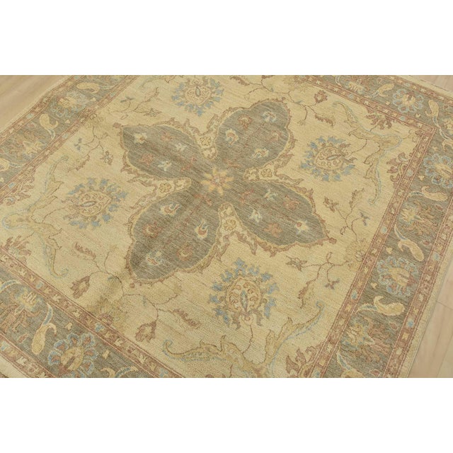 A traditional Ziegler rug hand-knotted with fine wool on a cotton foundation. This rug features a central medallion...