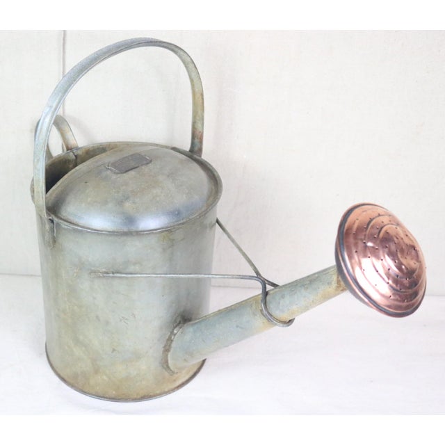 A traditional English garden watering can. It is made of iron with a copper water rose and has been professionally cleaned...