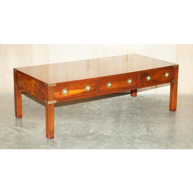 This vintage collectable Burr Yew & Elm wood and Brass fully restored Military Campaign three drawer coffee table This...