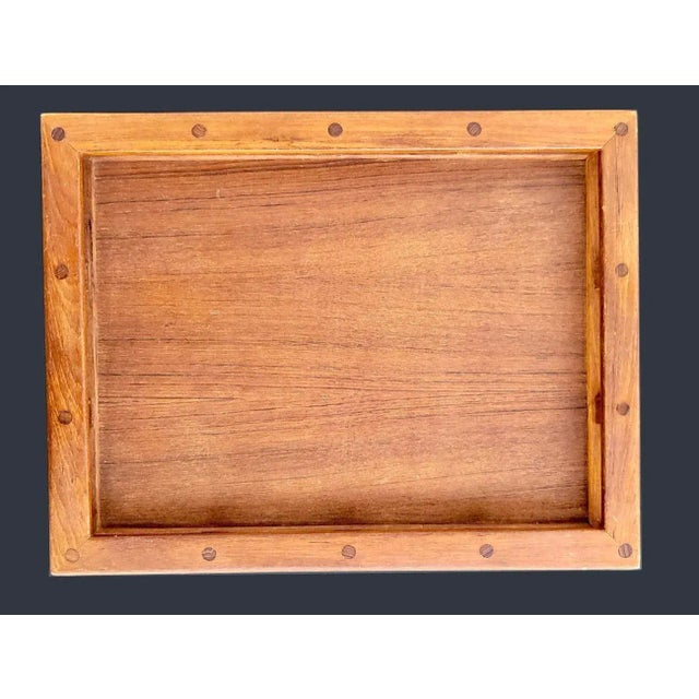 Resembling a ship's galley rail, this is a classic Teak wood "Captain's" (and also referred to as a Butler's) tray...