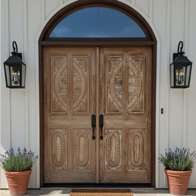 An exceptional pair of antique hand-carved double doors, designed to make a grand architectural statement for both...