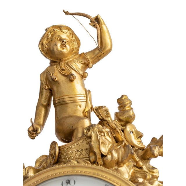 Louis XVI gilded bronze watch. Enamelled dial with hollow hands White marble pedestal richly decorated with gilded bronze,...