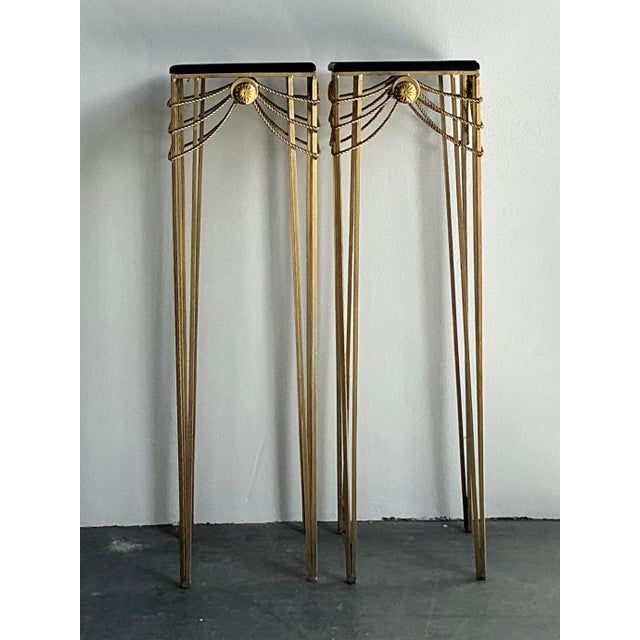 Elevate your interior architecture with this elegant pair of vintage Hollywood Regency pedestals. Perfectly capturing the...