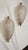 Pair of refined and delicate white Murano glass and brass wall sconces. The wall sconce has two brass wreaths, on which is...