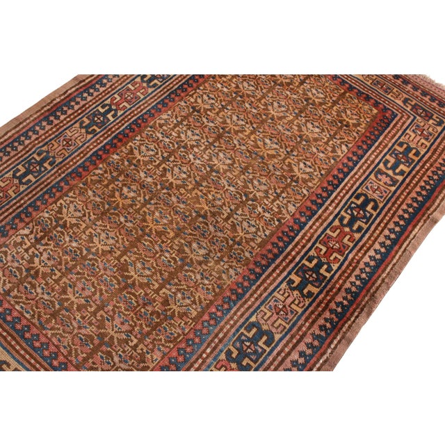 Made with hand-knotted wool originating circa 1900-1910, this antique Persian rug connotes a transitional Hamadan rug...
