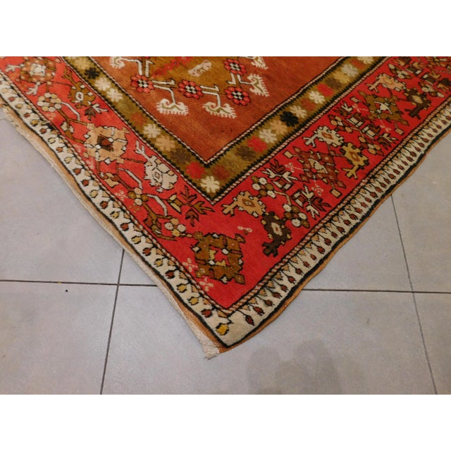 Multi medallion on orange field. Border decorated with intricate motifs. 4'8"x 7'4"