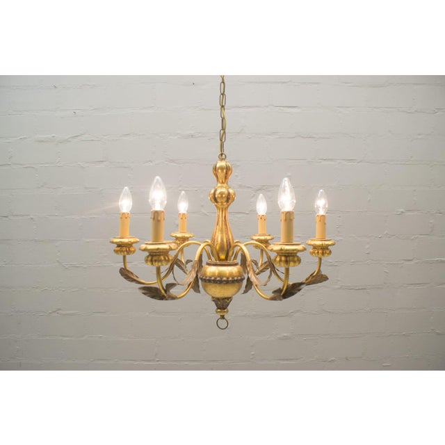 This vintage chandelier features six arms with E14 bulb sockets. Up to 250V (Europe/UK Standard).The wiring of this item...