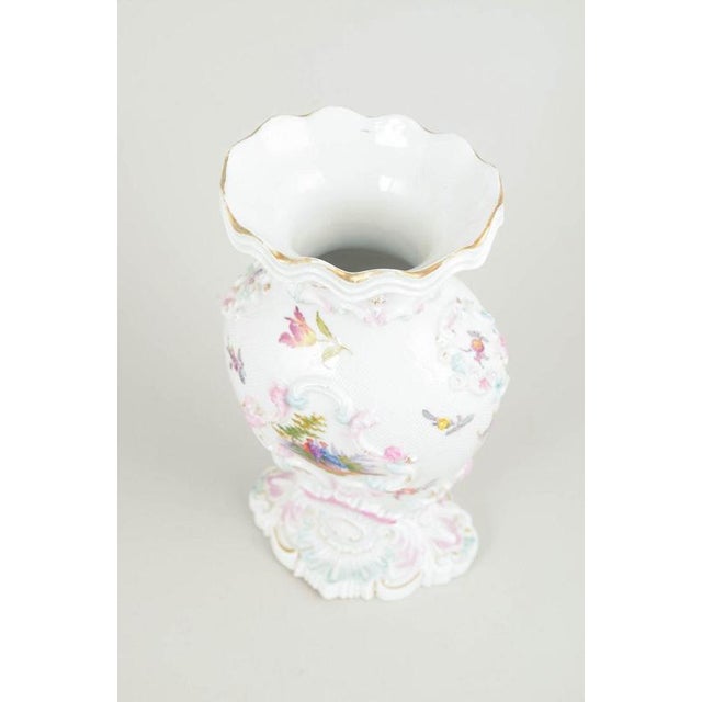 Meissen vase, early 19th century. Rare porcelain vase with rich relief modelling and hand-painted polychrome floral and...