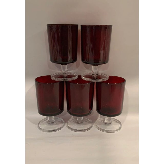 A set of Arcoroc France ruby red glasses. 5 pedestal stem mid century stunners.
