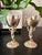 Elegant pair of vintage gold-toned cherub chalice stands, designed in a Renaissance-inspired style featuring detailed...