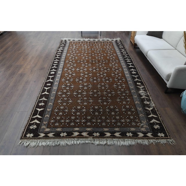 Vintage Persian Hand-Knotted brown area rug is a semi-antique vintage area rug. The '60s Eastern region of Anatolian's...