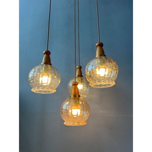 Hustadt Leuchten vintage cascade chandelier with 4 glass shades. The shades have a decorative shape and the glass has a...
