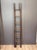 An early 20th century English pole ladder clad in dark brown leather and detailed with brass nailhead trim. The piece...