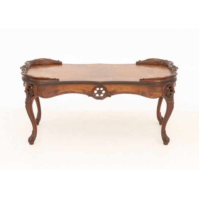 Rococo Style Marquetry Inlaid Walnut Coffee Table, the top inlaid with scrolling floral motifs and above carved wood...