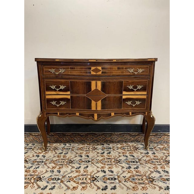 Striking and characterful rosewood chest of drawers with beautiful parquetry inlay throughout. This triple-drawer piece...