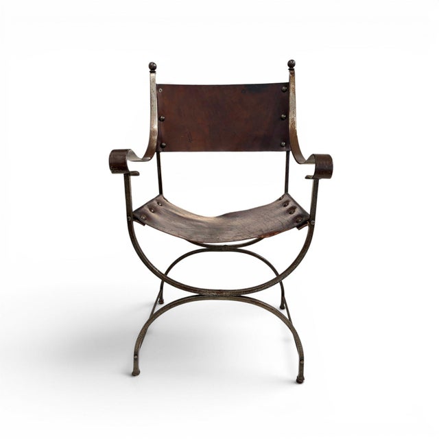 This striking pair of early 20th century Savonarola chairs features sculptural metal frames paired with richly aged...