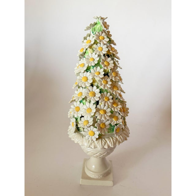 A very cheerful mid-century Italian ceramic daisy topiary. An all-white embossed urn shape vessel supports a finely...