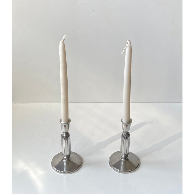 A pair of candlesticks designed by designer and sculptor just andensen in denmark during the 1930s or 1940s. They are made...