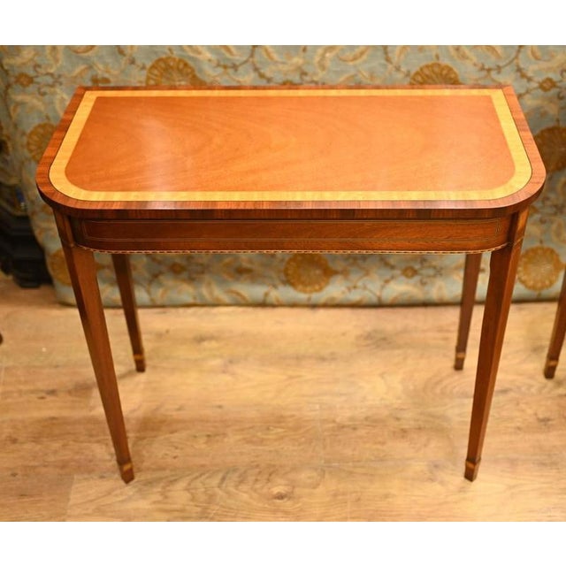 Refined pair of mahogany console tables in the Regency manner Classic design with tapered legs and d end shaped tops...