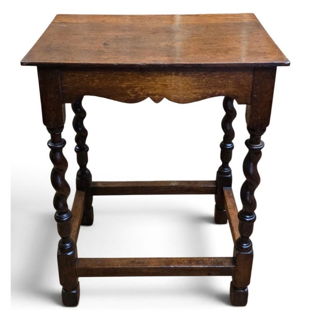 Late 17th-century English oak side table exhibiting the robust craftsmanship and distinctive turned ornament associated...