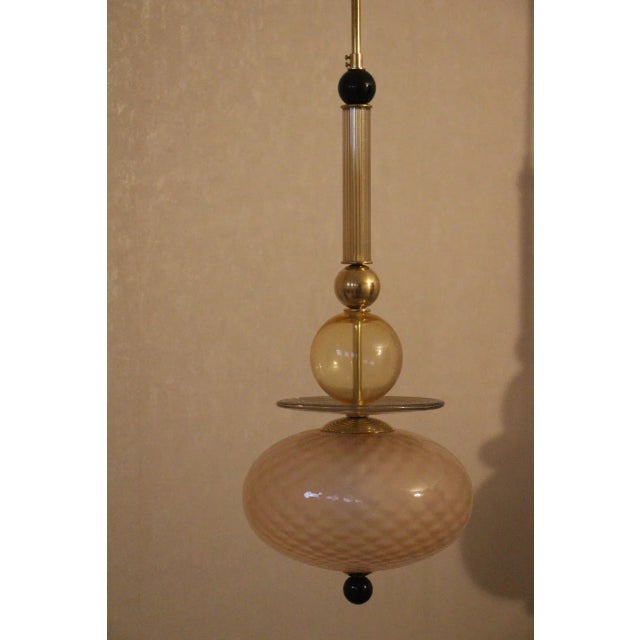 This very chic pair of long chandeliers in pink,yellow and black Murano glass is very unusual. It features very soft and...