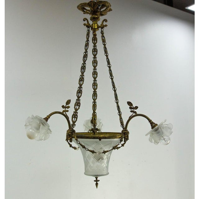 Romantic chandelier or lustre, french polished and engraved glass and brass. Made circa 1910, this ceiling pendant takes...