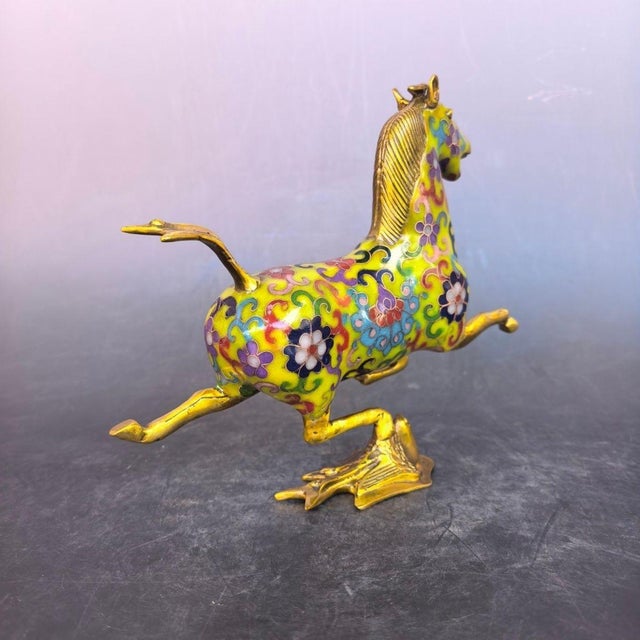 This is a finely crafted antique cloisonné enamel sculpture of a galloping horse, a traditional symbol of power,...