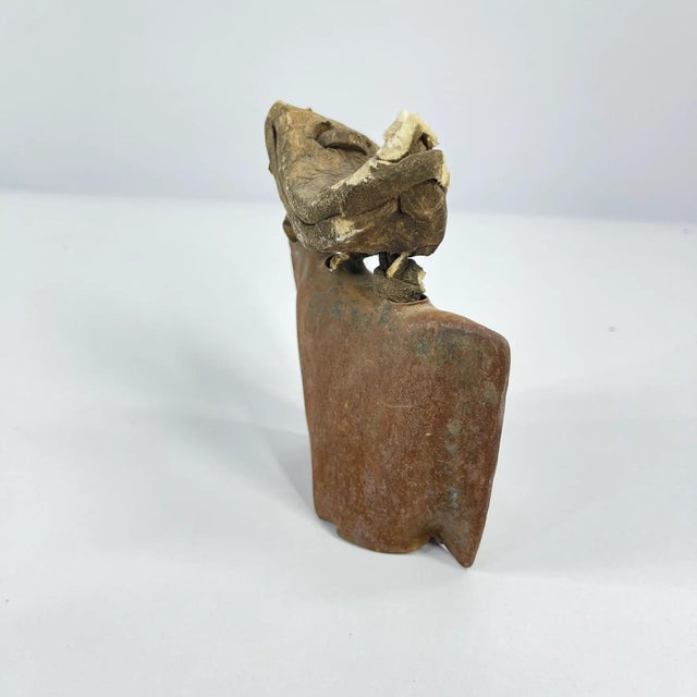 Hand-forged metal bell used by herders in rural Ghana to help locate goats and other livestock while grazing. Attached to...