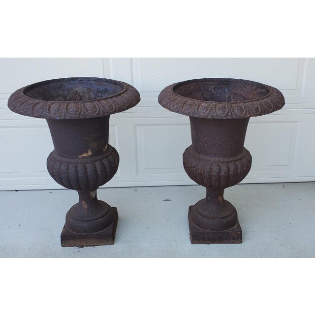 Antique pair of 30 1/2 inch Tall Large Cast Iron Fluted Campana Urns Outdoor Garden Planters Set of 2 A superb pair of...