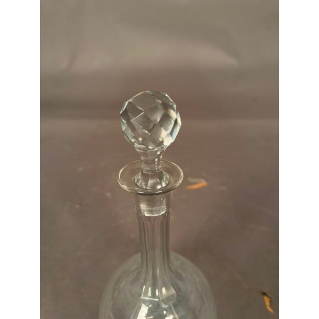 Elegant cut glass bottle or decanter with fitted stopper, dating to circa 1920s. Designed for decanting and serving...