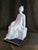 This figurine by the celebrated artist Camille Tharaud of Limoges. This piece features a graceful woman seated in a...