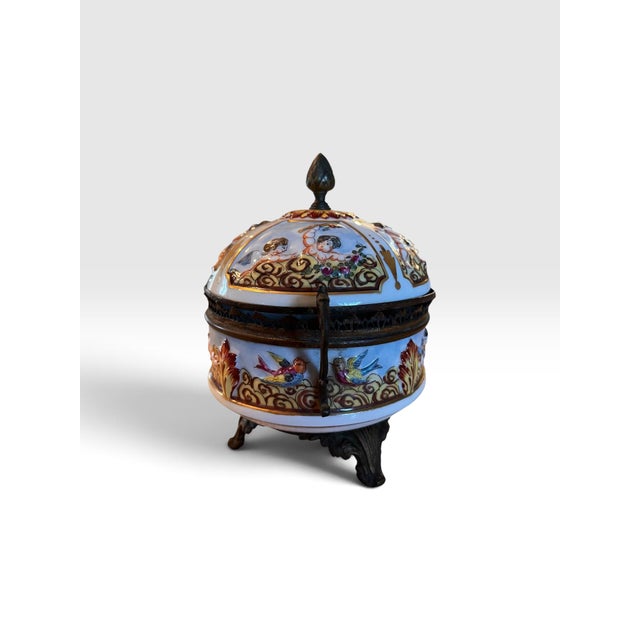 Bring a touch of French elegance to your décor with this charming hand-painted porcelain bonbonnière or trinket box....