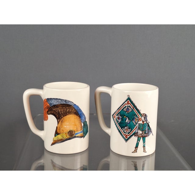 Rare set by Bucciarelli, Milan, in excellent condition. Two handled mugs with motifs of historical flags, clothing, and...