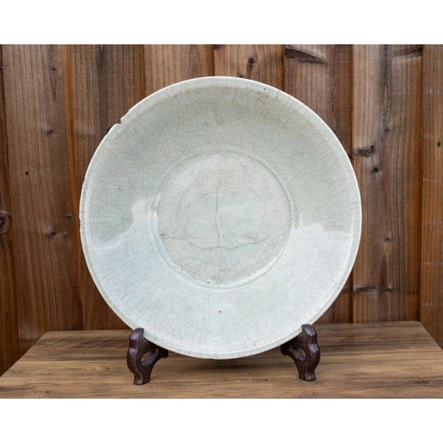 An impressive antique Chinese Longquan celadon charger dating to the Ming dynasty, 1368–1644, distinguished by its...