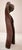 A tall, abstracted bronze figure, built from one continuous sweeping curve that loops up and around to form a rounded head...