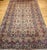 Step into timeless elegance with this vintage oversized Persian Kerman rug, handwoven in the early 1900s. Featuring a...