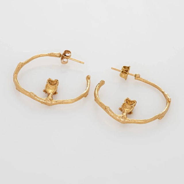 Distinct and stylish pair of diamond owl hoop earrings crafted in 14k yellow gold. Four round brilliant cut diamonds total...
