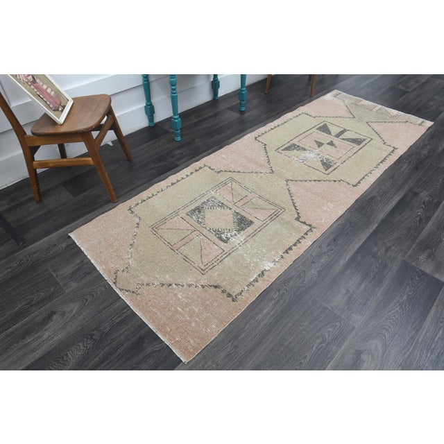 Vintage Hand-Knotted runner rug is a semi-antique vintage runner rug. The '70s Eastern region of Anatolia's unique rug is...
