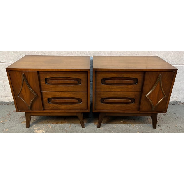 A pair of mid century modern walnut nightstands with faux drawer doors made by Young Manufacturing. Beautiful star...