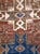 A vintage Caucasian Kazak accent rug with a geometric tribal design of 2 blue 8-point stars forming arrowheads and 1 cream...