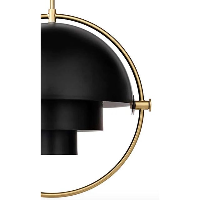 Louis Weisdorf 'Multi-Lite' pendant lamp in black / brass. Designed in 1972 by Weisdorf, this is an authorized re-edition...