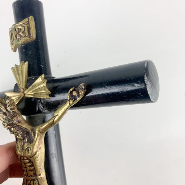 Incredible vintage Jesus Christ crucifix in brass on black wooden cross. Inri above His head. Hook to hang on wall. Lovely...