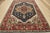 A traditional tribal Heriz rug hand-knotted with an all-wool pile on a cotton foundation. This oriental rug features a...