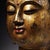 Majestic heavy bronze bust of Shakyamuni Buddha, finished in textured mud gilding with beautifully aged mottled patina....