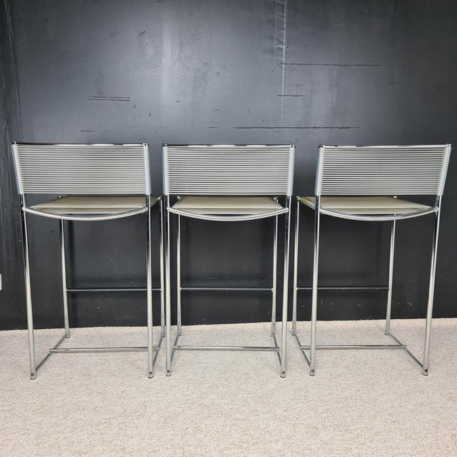 Series of three bar stools by Italian designer Giandomenico BELOTTI for Alias ​​70's Very airy lines for these stools with...